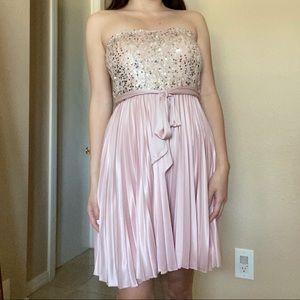 Pink satin and sequin strapless mini dress with pleated skirt and tie at waist